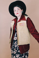 Men's vintage 1980's Swingster, World of Wearables, Made in USA label size medium sleeveless tan suede vest with a cream shearling liner and brass zipper up the front.