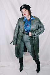 Men's or women's vintage 1970's Made in Argentina label knee length dark grey colored leather trench coat with double lapel and button closure.