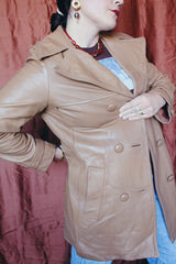 Women's vintage 1970's Nordstrom label long length long sleeve tan brown colored double breasted leather trench coat.