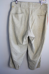 Men's vintage 1940's Rawlings, St. Louis label capri length baseball pants in grey wool material with red stripe piping along each side of leg.