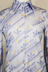 Women's vintage 1970's Devon long sleeve button up blouse with a dagger collar. Light purple color with all over ditsy floral print.