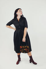 vintage 1950's paisley printed midi length dress with 3/4 arms and button up bust with small collar dark green front