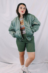 Men's or women's army zip up bomber jacket with long sleeves. Army green color with orange satin liner. Reversible.