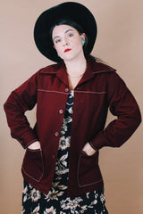 Women's or men'd vintage 1970's size medium long sleeve maroon color button up lightweight western style jacket with pockets and contrast stitching.