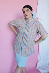 Men's or women's vintage 1970's The Fox, JCPenney label short sleeve button up shirt in yellow, grey, blue, and mauve all over plaid print. Tortoise colored buttons.