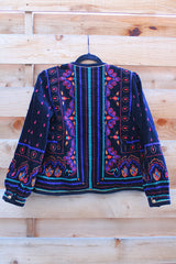 Women's vintage 1980's Saxton Hall, Made in Japan label long sleeve black velvet jacket with all over multicolored print and gold buttons.