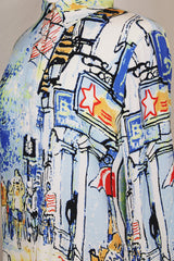 Women's vintage 1980's Michael Leu label long sleeve button up blouse with small collar, white buttons, and all over novelty print in a silk material.