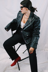Men's vintage 1980's black genuine leather zip up motorcycle style jacket. All over silver hardware, popper buttons, and and zippers.