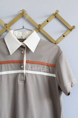 Women's vintage 1970's King Louie Creation, Made in USA label short sleeve polyester material polo top in light beige with cream and orange trim.