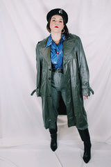 Men's or women's vintage 1970's Made in Argentina label knee length dark grey colored leather trench coat with double lapel and button closure.