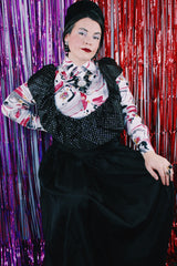 Women's vintage 1980's sleeveless off the shoulder ankle length black colored prom dress. Has a ruffled collar with all over silver metallic polka dots.