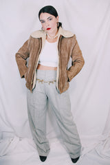 Men's or women's vintage 1970's light tan brown suede leather jacket with cream soft shearling liner. Zipper front closure and side pockets.