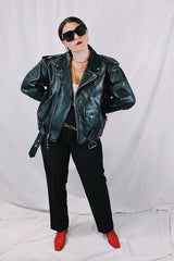 Men's vintage 1980's black genuine leather zip up motorcycle style jacket. All over silver hardware, popper buttons, and and zippers.