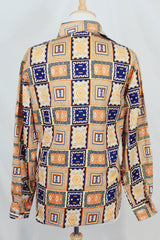 Men's vintage 1970's Envoy label long sleeve button up shirt with dagger collar with all over orange and navy abstract print.