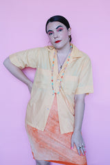 Men's or women's vintage 1960's Crystalaire, A Kentfield Exclusives short sleeve light orange colored button up shirt with two chest pockets.