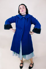 Women's vintage 1960's Jack Bloom California label long sleeve royal blue color coat. Ankle length with grey fur trim around collar and cuffs.