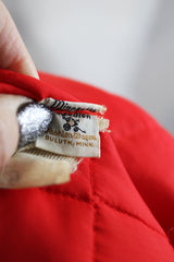 Men's or women's vintage 1980's Minnesota Woolen, Amalgamated Workers of America label long sleeve red nylon quilted lightweight puffy jacket with popper buttons.