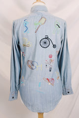 Men's or women's vintage 1970's BJ-R, Long Tail - Form Fit, Made in Hong Kong label long sleeve light blue denim chambray button up shirt with colored embroidery all over.