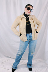 Women's vintage 1960's Union Made, Genuine Heeksuede Made in Holland label long sleeve short length tan colored suede button up lightweight jacket. Two front pockets and pink liner.