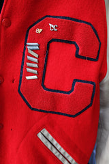Men's vintage 1987 Nelson's Jackets, Portland, Oregon label long sleeve cream and red colored varsity letterman jacket in wool and nylon material. Has patches and pins.