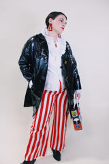 Women's vintage 1960's long sleeve black vinyl material jacket with gold buttons and hardware. Fully lined and has two side pockets.