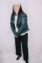 Men's or women's vintage 1970's Genuine Leather, Made in Mexico label long sleeve black leather moto leather jacket with silver hardware.