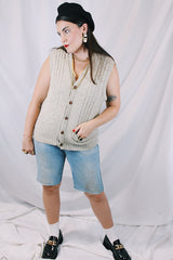 Men's or women's vintage 1970's Jantzen, Made in USA label sleeveless button up sweater vest cardigan in a wool and acrylic material. Oatmeal color with navy speckles and a cable knit texture.