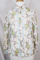 Women's vintage 1970's Knit Editions by Ship 'n Shore long sleeve button up blouse with a dagger collar in an all over white and blue stripes pattern and floral print.
