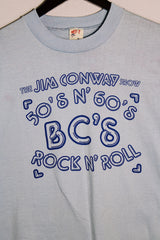 Men's or women's vintage 1970's Hef-T, Tee Jays, Made in USA label baby blue tee with Jim Conway show bright blue graphic on the front in cotton and polyester material.