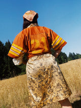 short sleeve burnt orange cropped football jersey with yellow stripes, wording, and trim vintage 1970's