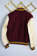 Women's or men's vintage 1982 Nelson's Jackets, Portland, Oregon label long sleeve letterman jacket with a maroon wool body and cream colored leather arms. Yellow stripped trim and popper buttons. Embroidery on chest.