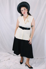 Women's vintage 1970's Montgomery Ward sleeveless button up sweater vest cardigan in a cream white color. Acrylic material and all over cable knit texture.