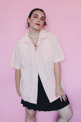 Men's vintage 1970's Mexacali label short sleeve peach orange colored button up cabana shirt with white embroidery and pleats on the front.