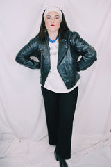 Men's or women's vintage 1970's Genuine Leather, Made in Mexico label long sleeve black leather moto leather jacket with silver hardware.