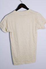 Men's or women's vintage 1980's Screen Stars, Made in USA label short sleeve light tan colored tee with blue graphic on the front in a cotton and polyester material.