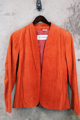 Women's vintage 1970's Deerskin Quality Leathers long sleeve open front lightweight suede leather jacket in a vibrant burnt orange color.