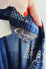 Men's or women's vintage 1970's Chemise Et Cie label long sleeve navy button up shirt with dagger collar and all over multi colored abstract print in slinky shiny polyester material.