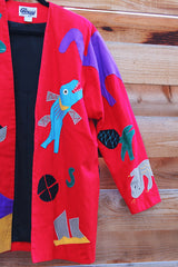 Women's vintage 1980's Mr. Girasol, Made in Mexico label long sleeve open front lightweight jacket in red with all over multicolored animals.