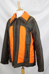 Women's or men's vintage 1970's Cascade, Made in Korea label long sleeve zip up brown and orange colored nylon puffer jacket.