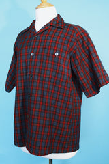 Men's vintage 1960's Pendleton short sleeve button up plaid shirt in a lightweight wool material. Red and grey colors with one chest pocket.