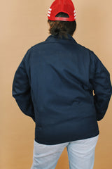 Men's or women's vintage 1970's Unitog Company, Union Made in USA label size large long sleeve navy blue station jacket that zips up the front with red nylon liner.