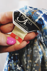 Women's vintage 1970's Mr. Alex, a division of Alex Colman Inc. label long sleeve button up blouse with dagger collar in all over white and blue colored abstract print.