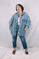 Men's or women's vintage 1980's Levi's medium wash denim lightweight jacket with brass hardware. Buttons up the front and four pockets. Size XXL.