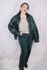 Men's vintage unknown, maybe around 40's-50's long sleeve black distressed leather jacket with zipper front closure and buckles on cuffs.