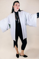 Women's vintage 1960's long sleeve textured kimono. Baby blue color with blue and white floral liner. Ties in the front. Wide big sleeves.