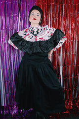 Women's vintage 1980's sleeveless off the shoulder ankle length black colored prom dress. Has a ruffled collar with all over silver metallic polka dots.