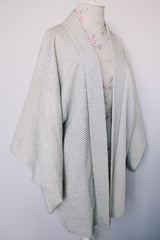 Women's vintage 1960's long sleeve textured kimono. Baby blue color with blue and white floral liner. Ties in the front. Wide big sleeves.