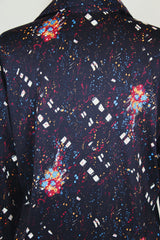 Men's vintage 1970's Maxi & Me California label long sleeve black slinky polyester material button up shirt with all over multi colored paint splatter print.