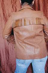 Women's vintage 1950's Custom Made by Milco-West, Portland, Oregon label long sleeve button up tan camel colored leather jacket with fringe trim. Western style with four pockets.