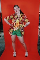 Women's or men's vintage 1970's Sundek, Made in USA label short sleeve button up shirt with dagger collar in cotton material with all over Hawaiian print in red, yellow, and green colors.